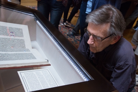 A library visitor views the volume of the Gutenberg Bible on display in the Widener Memorial Room.