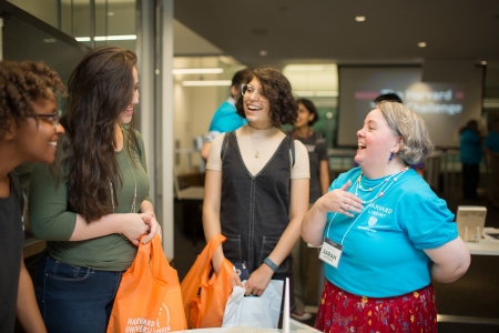 Sarah Hutcheon standing and laughing with students