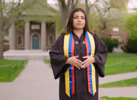 Woman graduate wearing robes in Harvard Yard