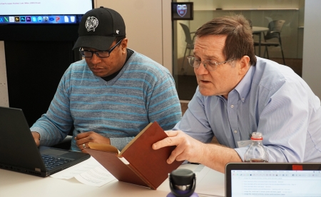 A library staff member works with an Unabridged participant. 