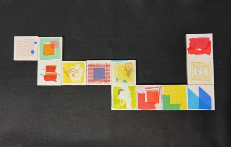 Letterpress printed magnetic blocks arranged in a snake-like formation 