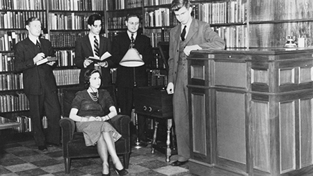 Poetry Room at Widener Library with a group of people standing and looking at the camera