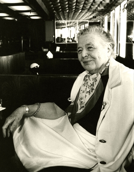 Marguerite Yourcenar sits smiling away from the camera