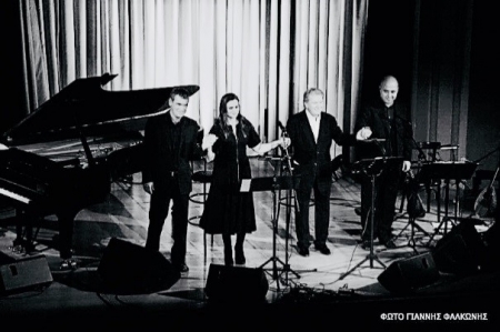 Greek musicians performing on a brightly lit stage