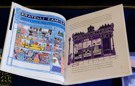 Page spread from MOTIF magazine. Left page shows a colorful illustration of the storefront of cheese and wine shop. Right page shows an illustration of a locksmith storefront.