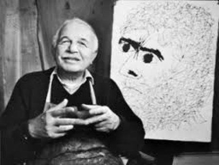Artist Ben Shahn seated in front of his work.  