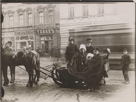Poliksena Nesterovna Shishkina-Iavein in a horse-drawn sleigh with her children and husband on Nevskii Prospekt during Maslenitsa, 1909.