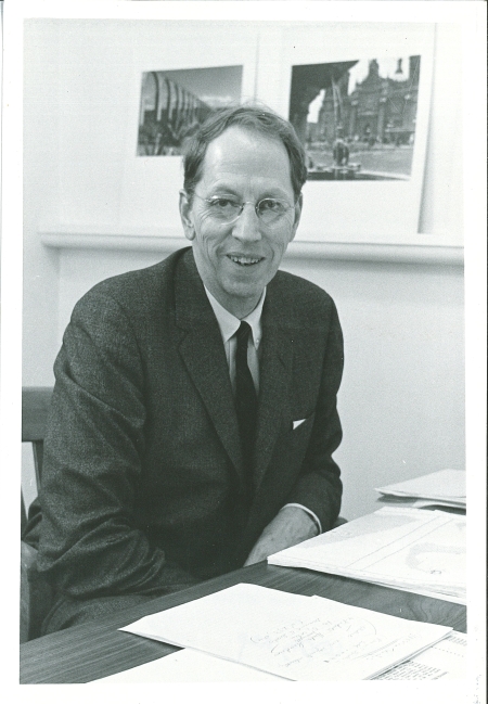 Black and white photograph of Howard T. Fisher sitting at his desk, circa 1960s.