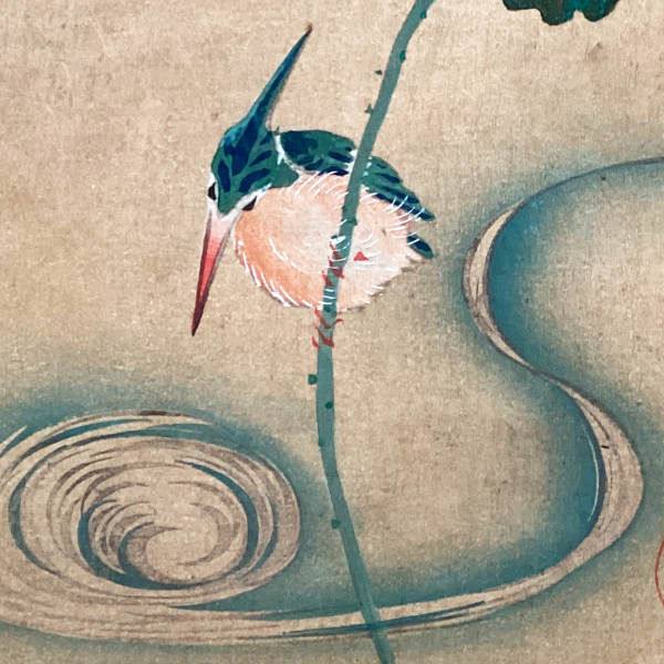 A photo of a woodblock print, which features two separate illustrations of birds in nature.