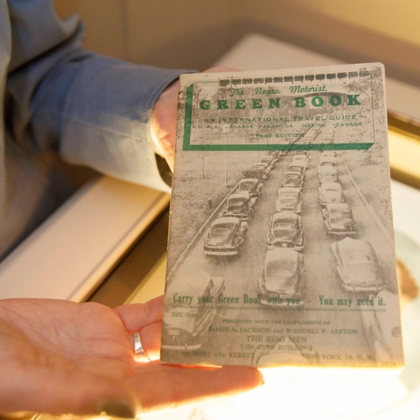 Hands holding the green book