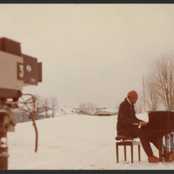 Pianist Randy Weston plays a grand piano in the snowy French Alps. 