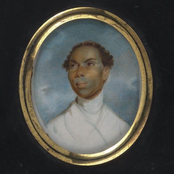 Black man with short curly hair, wearing a white garment