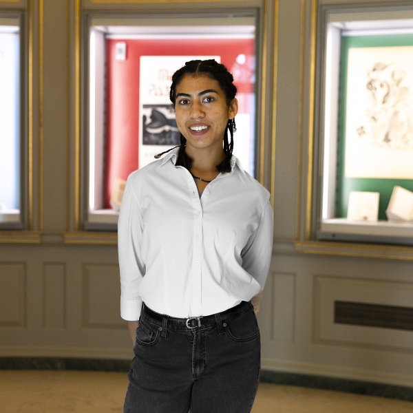 Chloe McKain stands in front of the exhibit she curated.