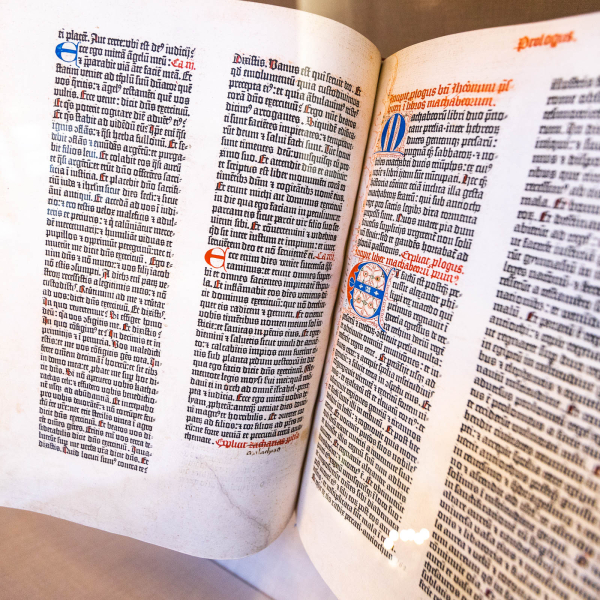  A view of the gutenberg bible held at Harvard Library, seen opened to a page with text