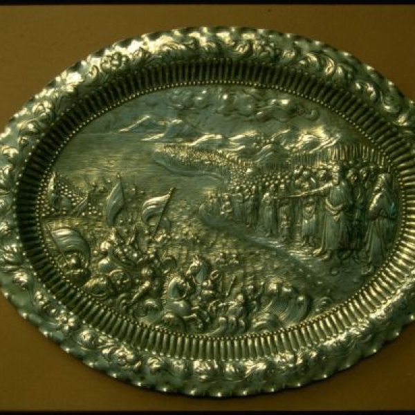 Metal seder plate depicting the parting of the Red Sea. 