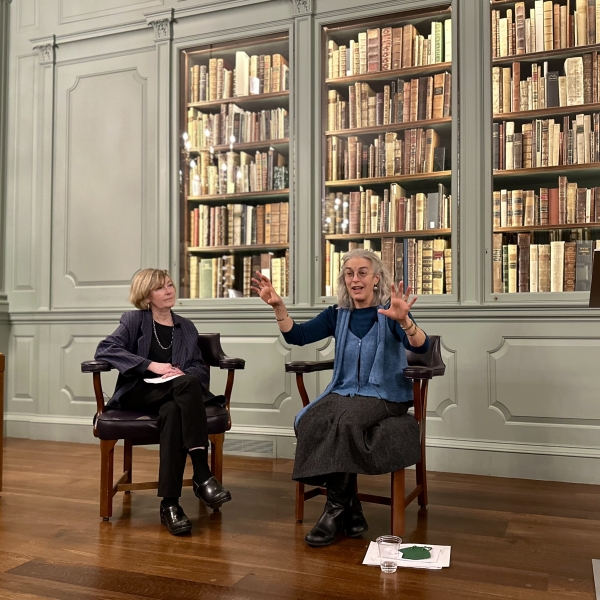 Two women talking at Houghton Library