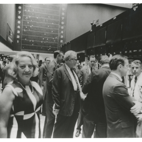 Muriel Siebert on New York Stock Exchange floor surrounded by men