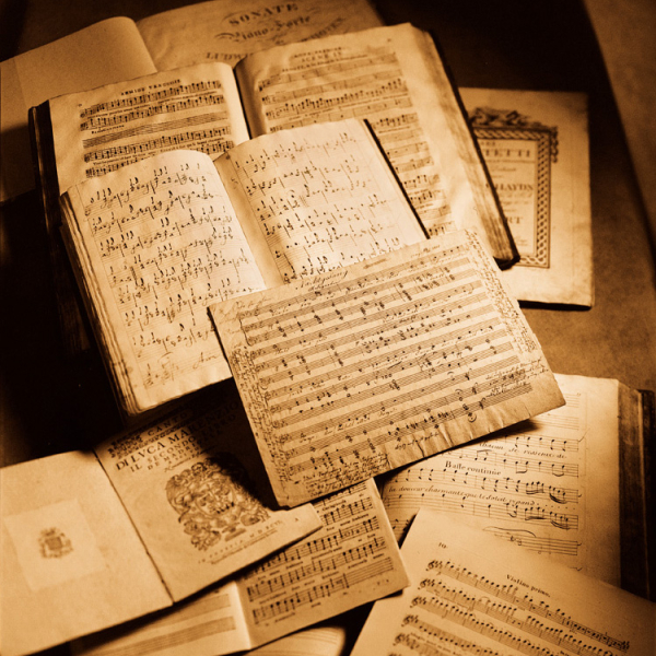 Musical scores arranged on a table.