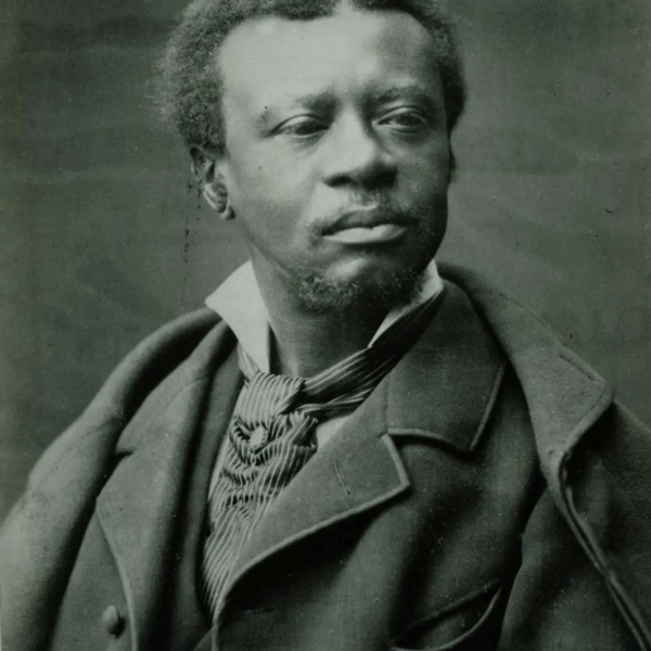 Black and white film portrait of composer Edmond Dédé, his face is serious and his gaze is cast off to the right of the image