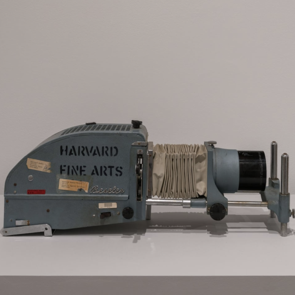 Vintage slide projector with 'Harvard Fine Arts' labeled on the side