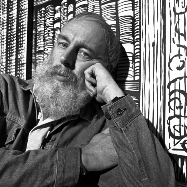 A photograph of Edward Gorey gazing at the camera.