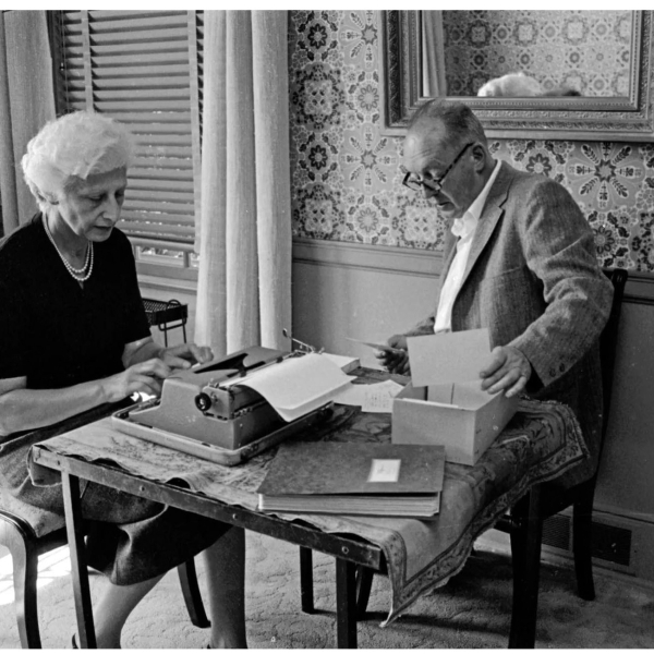 Vladimir and Vera Nabokov at a table. Vera is at a typewriter, working away.