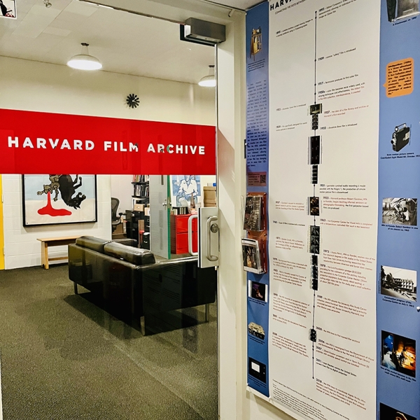 a view of the HFA film timeline poster next to the glass door of the offices