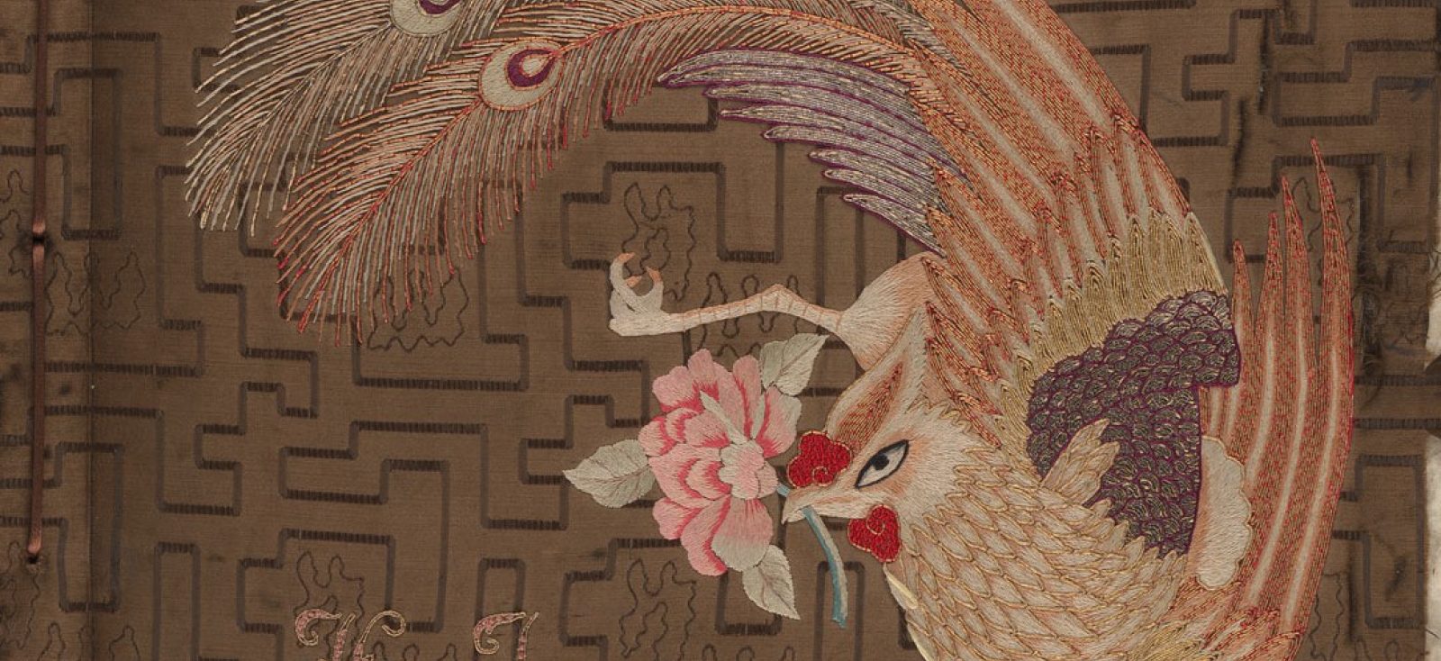 The cover of a photo album, with an illustration of a phoenix holding a peony.