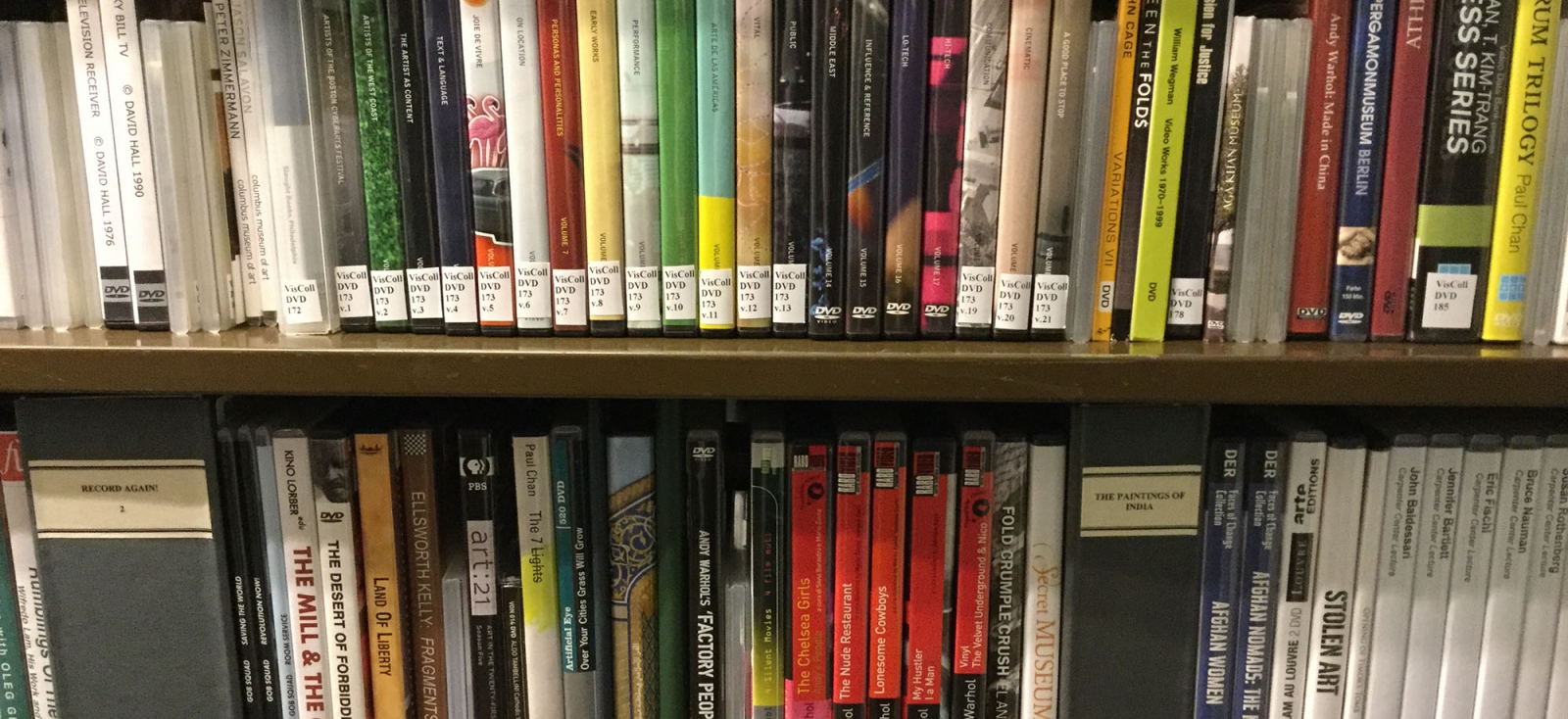 Color photograph showing DVDs in the media collection at the Fine Arts Library on the shelves