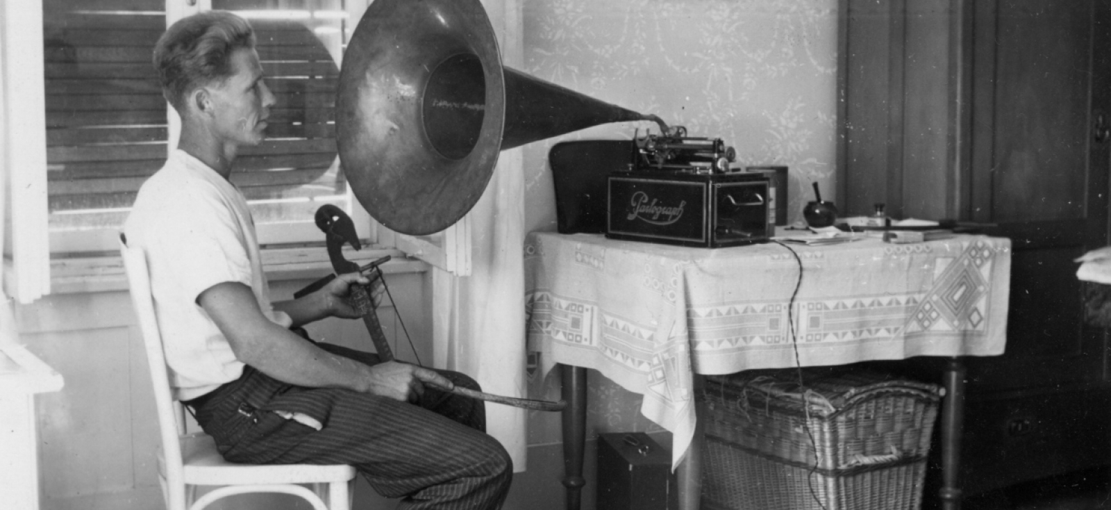 Nikola Vujnović sits at a table with a phonograph
