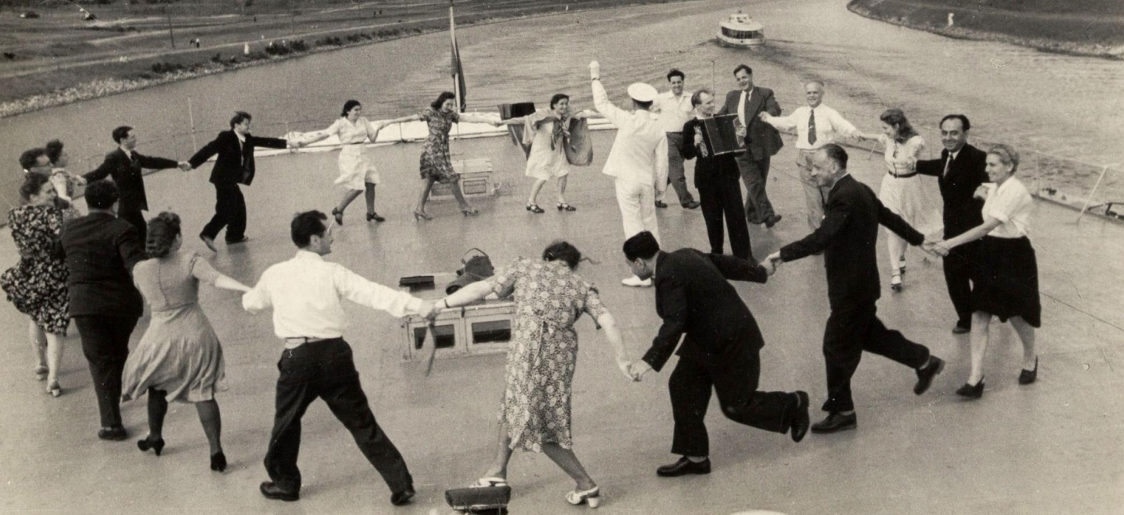 Participants of the executive committee of the World Federation of Trade Unions in Moscow dance the Yugoslav Kolo on the Moscow-Volga Canal.