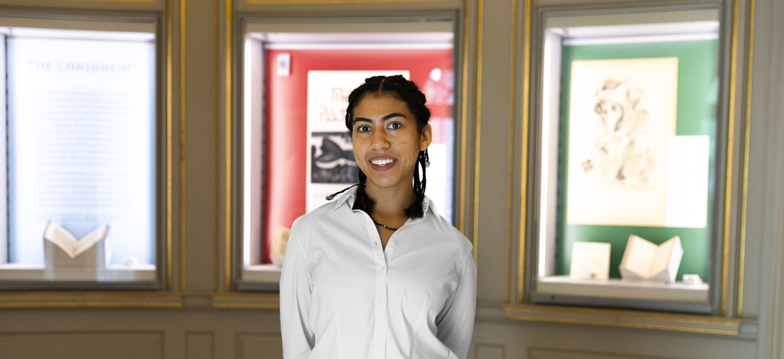 Chloe McKain stands in front of the exhibit she curated.
