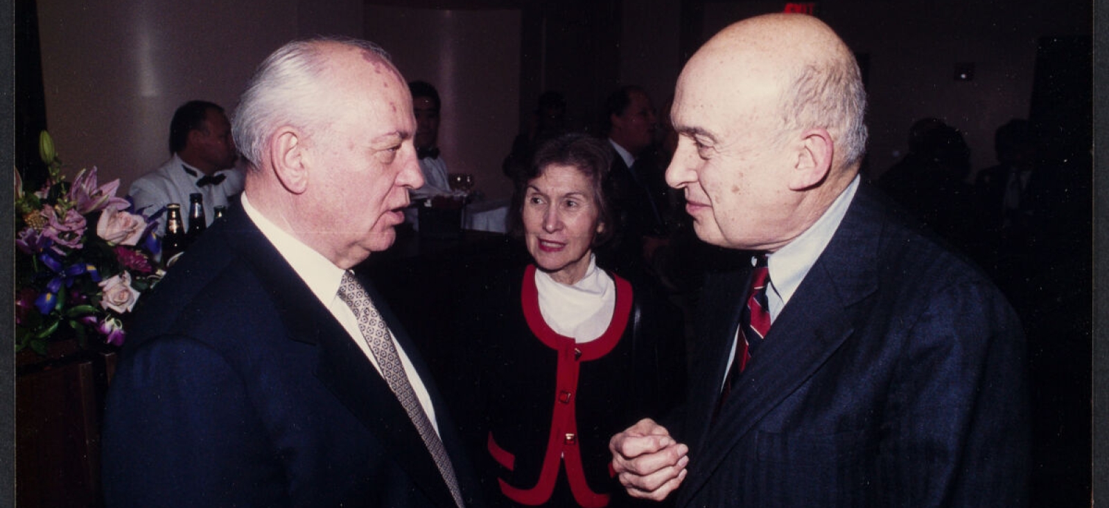 Mikhail Gorbachev (left) and Marshall Goldman (right) facing each other at an event. Merle Goldman is in background between them.