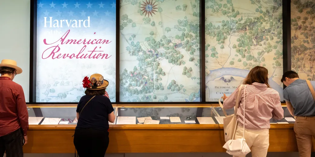 Visitors check out the Harvard and the American Revolution Exhibit