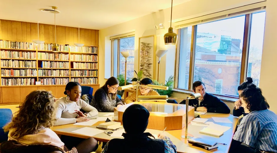 Visitors to the poetry room sit around a square table