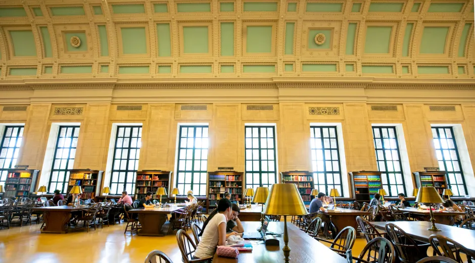 The Loker Reading Room at Widener, with large windows, long desks, and an ornate ceiling.
