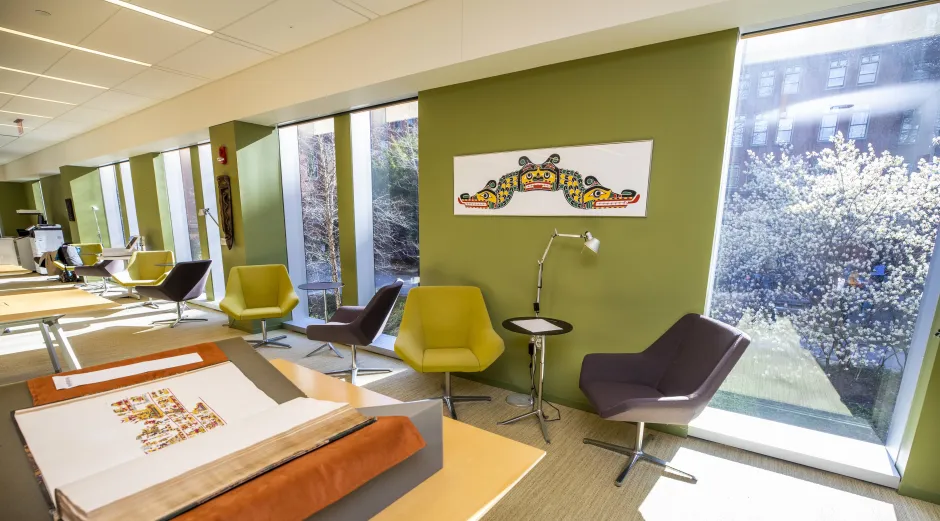 The interior of Tozzer Library is seen with chairs and desks