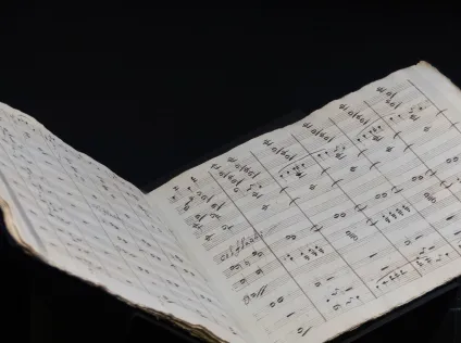 an open musical score with handwritten notes inside