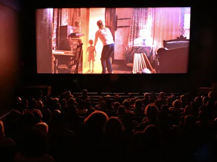 A screening at the HFA, with audience watching the screen.