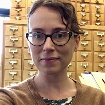 photo of April Collins in front of a library card catalog