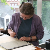 Susi pasting the endcap of an open book.