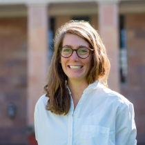 Headshot of Katie Mika taken outside in front of a Library building